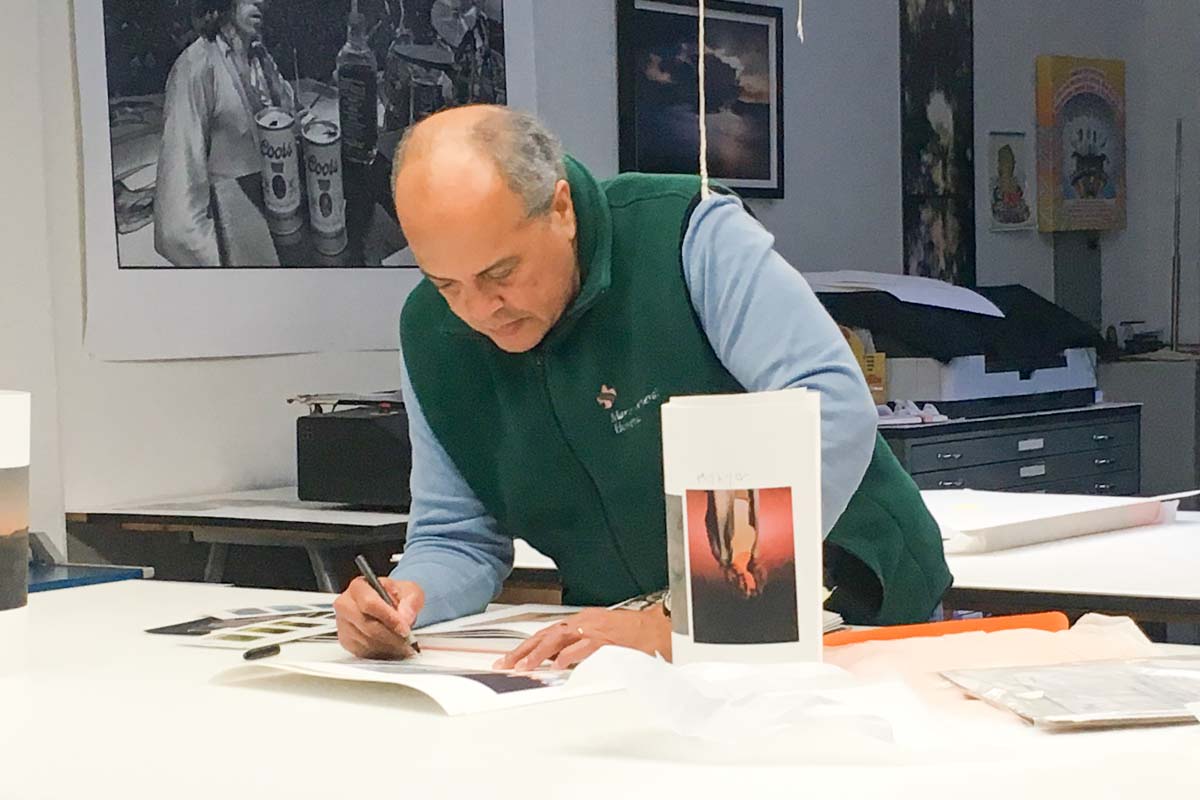   Garnell carefully examines and marks up a print, before preparing the next round of edits  